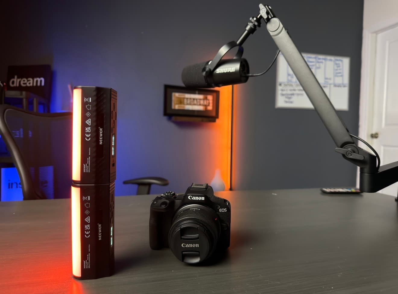 Canon EOS R50 with RGB tube lighting and a Shure mic on the boom arm