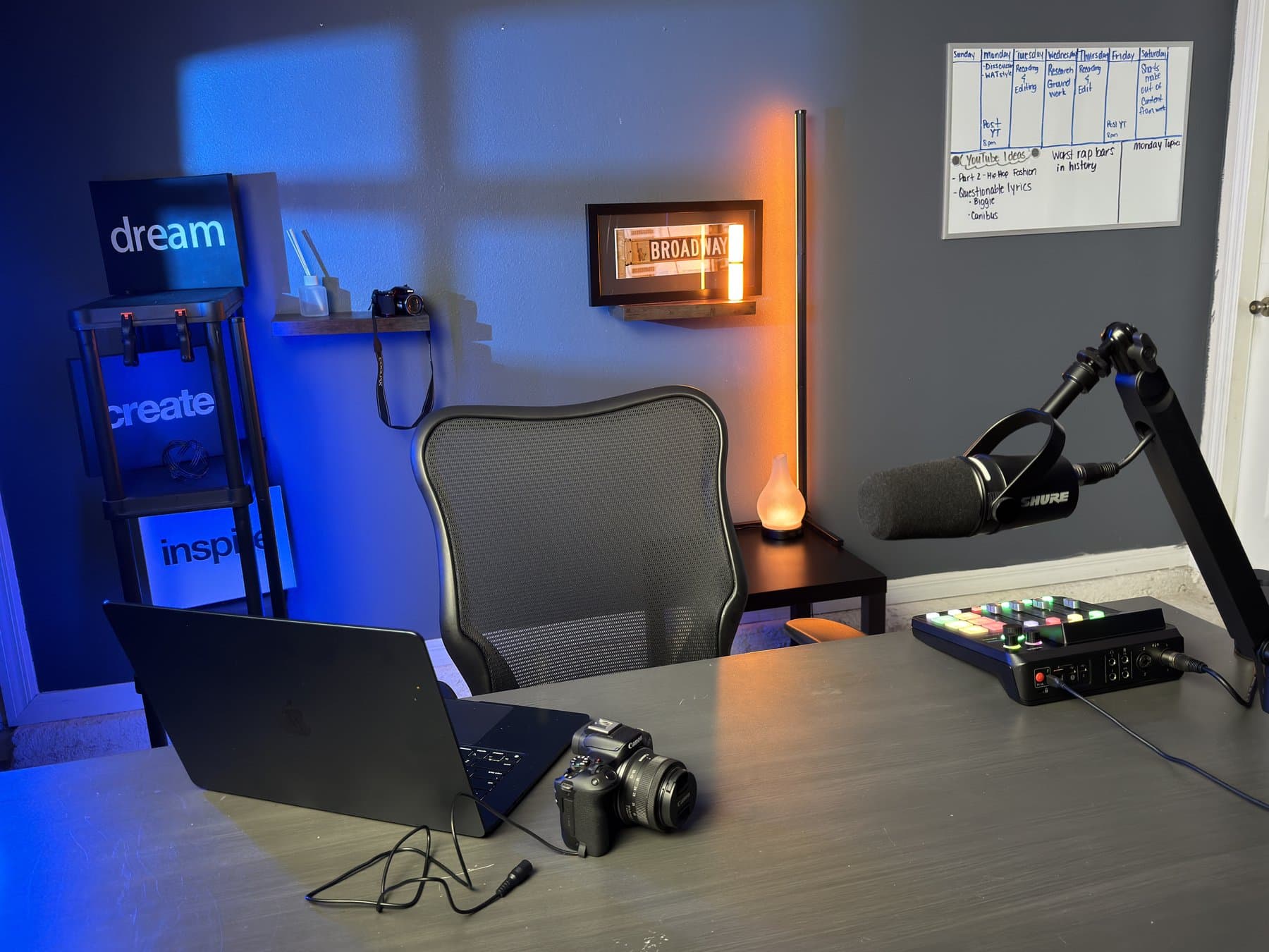 Creator workspace with camera, Shure microphone, laptop, and audio console