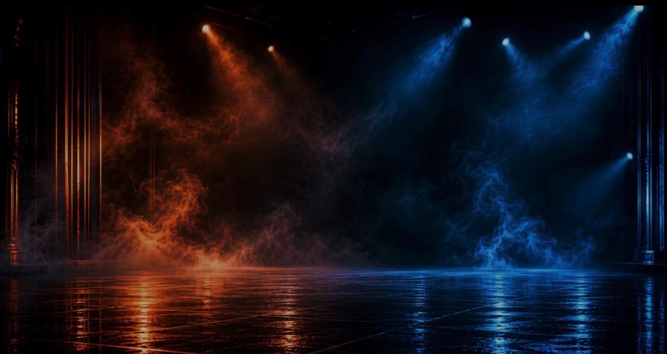 A dark stage lit in teal and orange